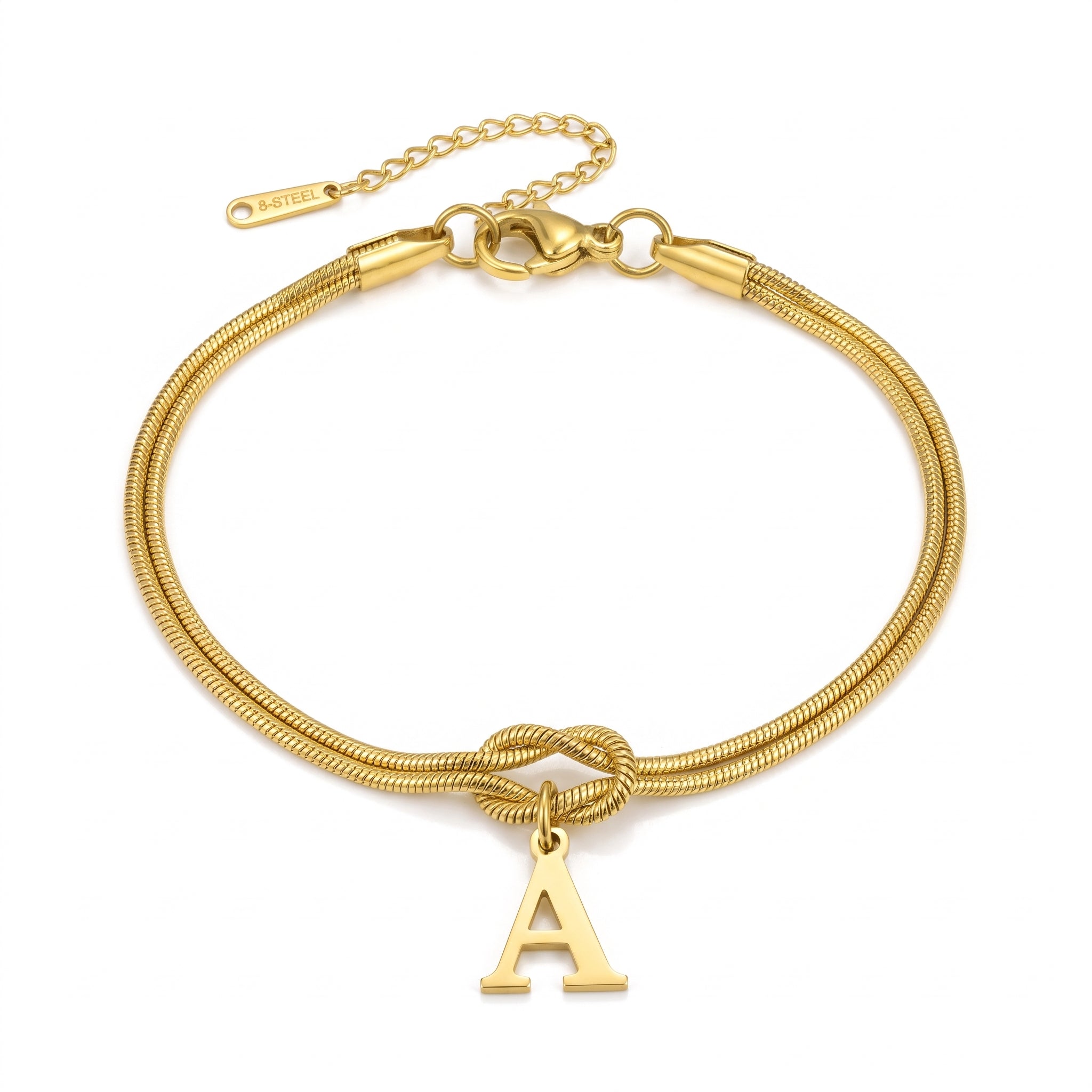 Gold initial bracelet with letter A charm laid flat on white