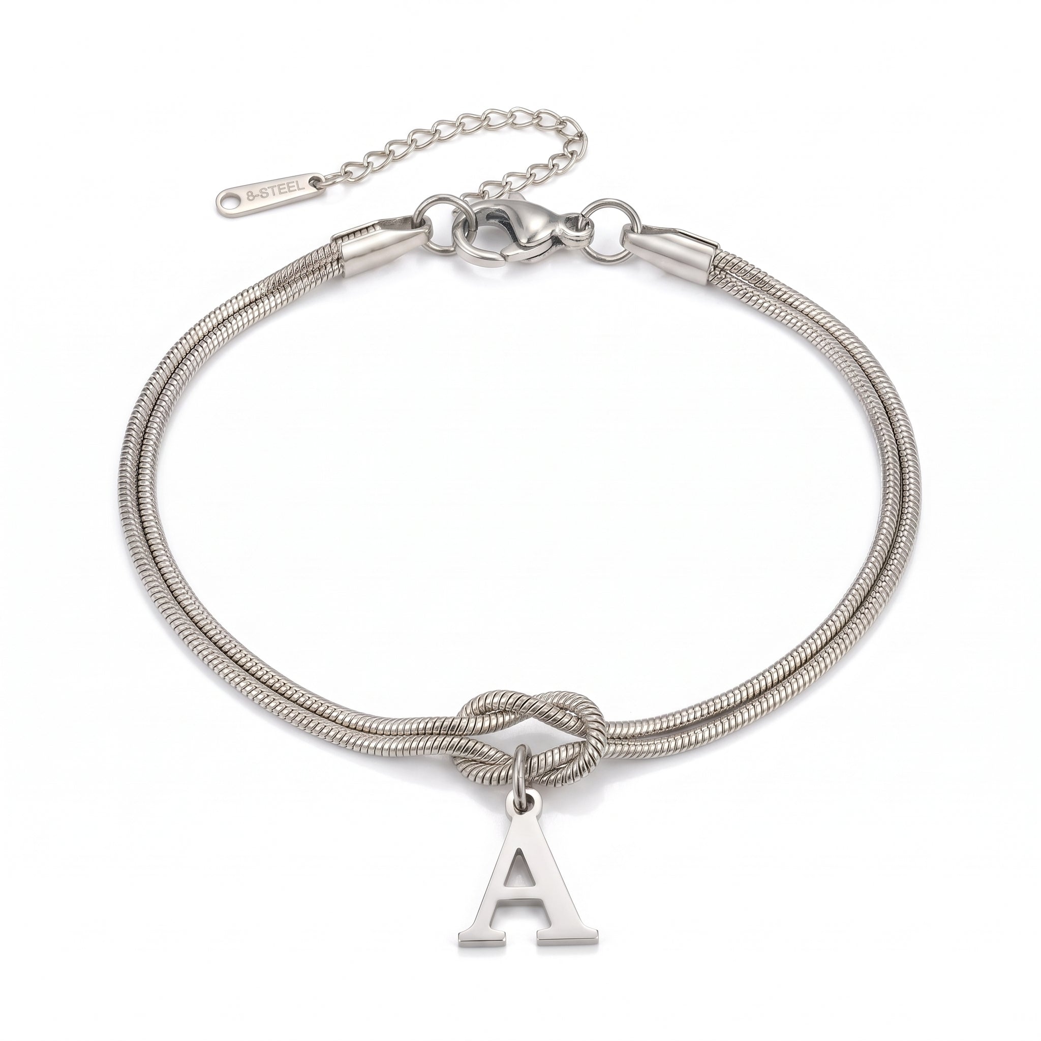 Silver initial bracelet with letter A charm laid flat on white