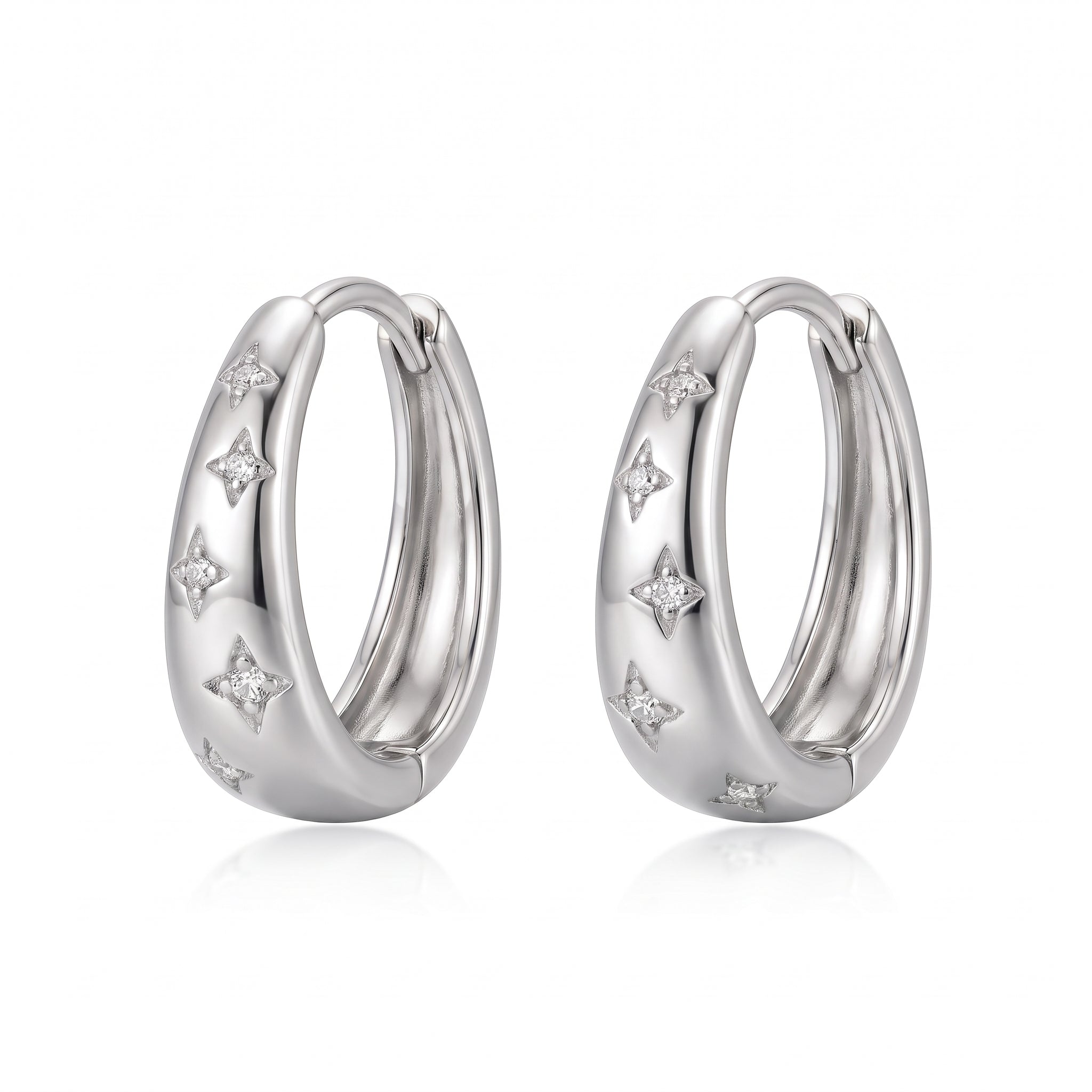 Silver star huggie hoop earrings side by side on white