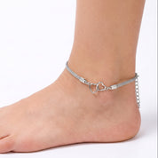 Silver double heart mesh anklet worn on the ankle, close-up