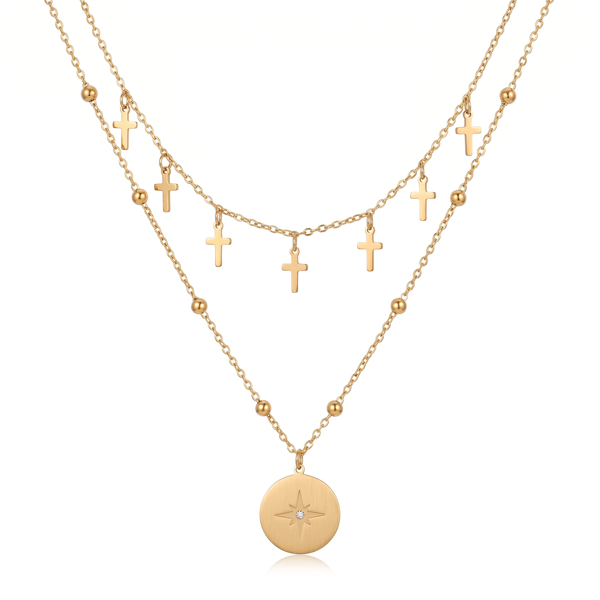 Gold cross charm chain and north star medallion on a beaded chain, white background