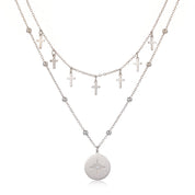 Silver cross charm chain and north star medallion on a beaded chain, white background