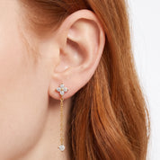Ear wearing Navalli gold clover drop earring Clarisse with fine chain and crystal drop