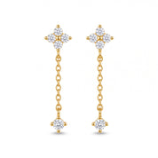Pair of Clarisse gold clover drop earrings with crystal clover studs on white background