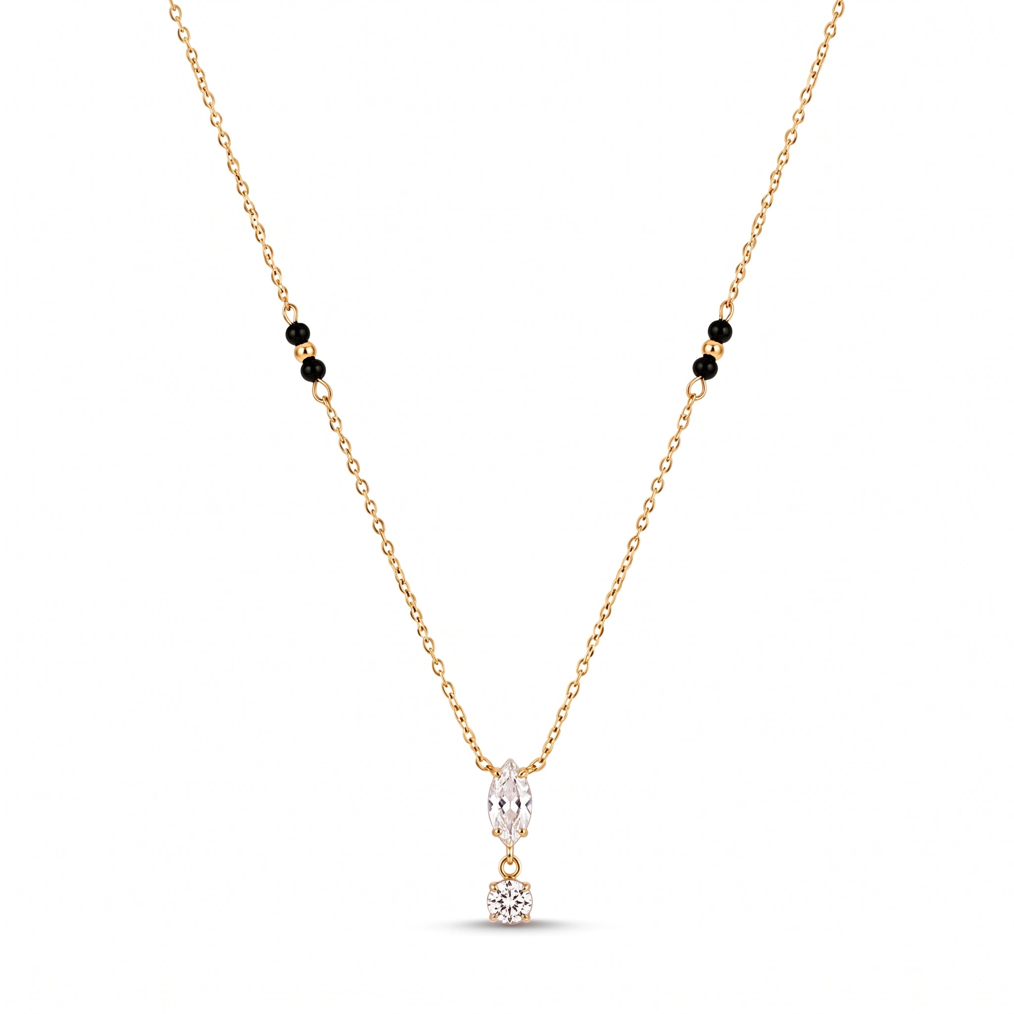 Gold crystal drop necklace laid out on a white background