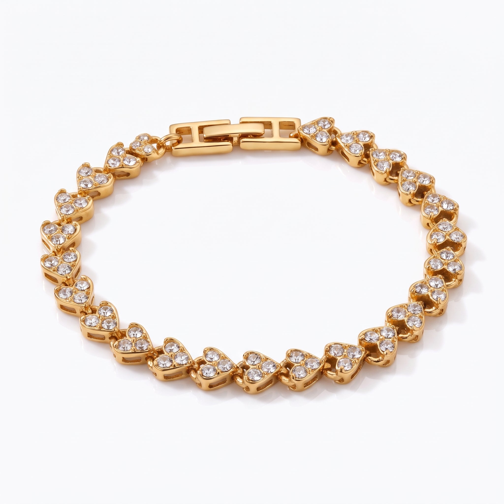 Coralie gold heart link bracelet with fold-over clasp on white background