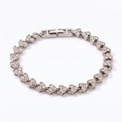 Coralie silver heart link bracelet with fold-over clasp on white background