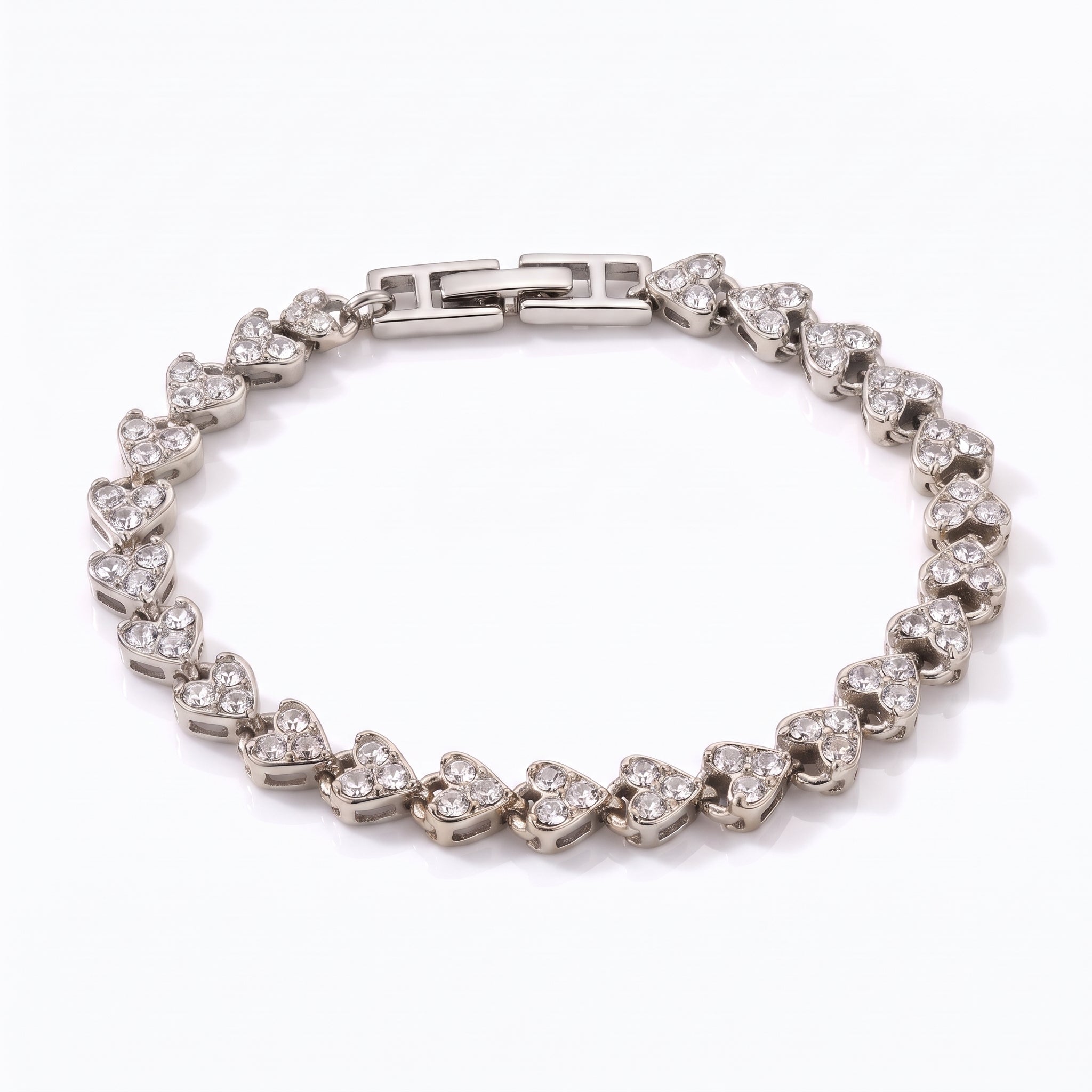 Coralie silver heart link bracelet with fold-over clasp on white background