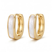 Gold square mother of pearl huggie earrings on white