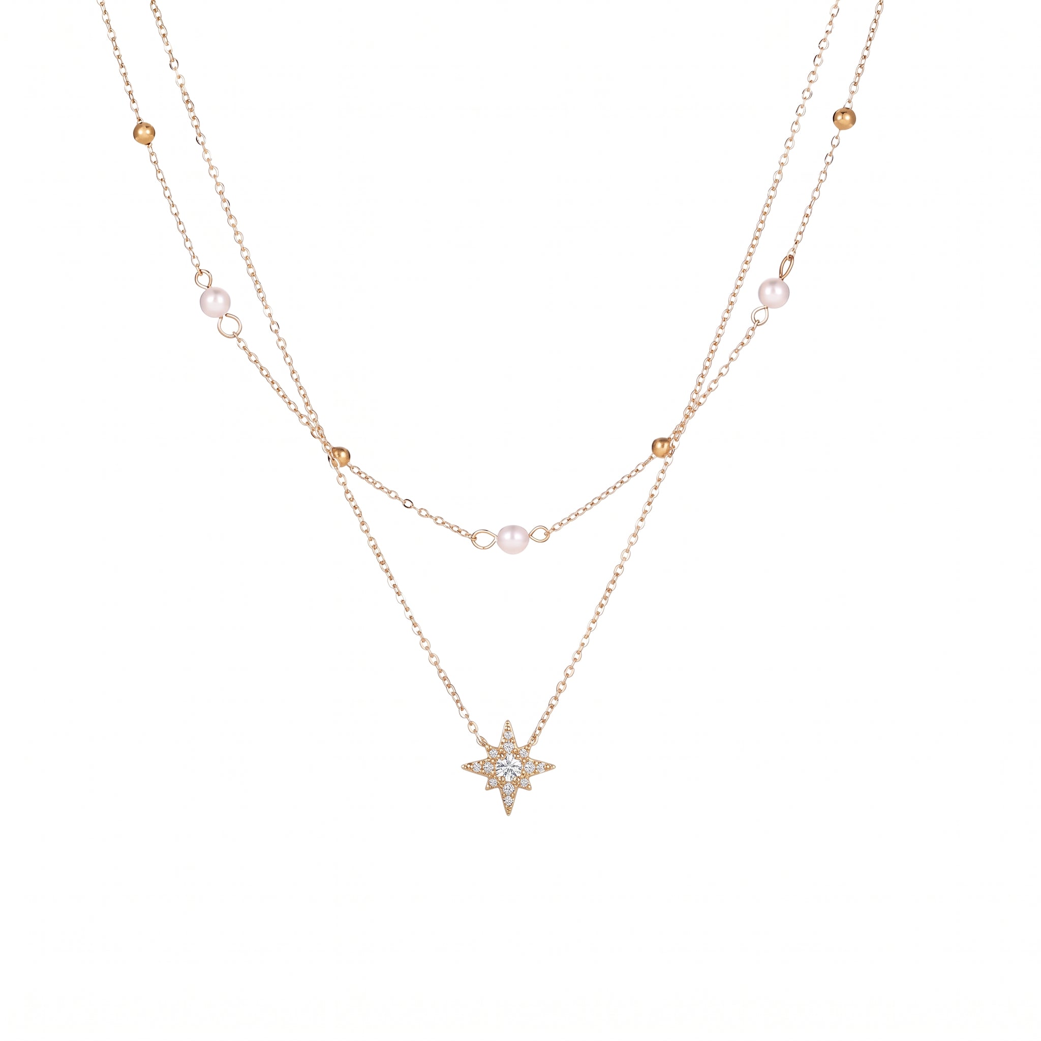 Gold pearl and bead chain with a crystal-set north star on white background