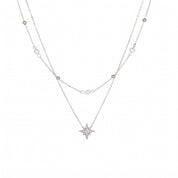 Silver pearl and bead chain with a crystal-set north star on white background