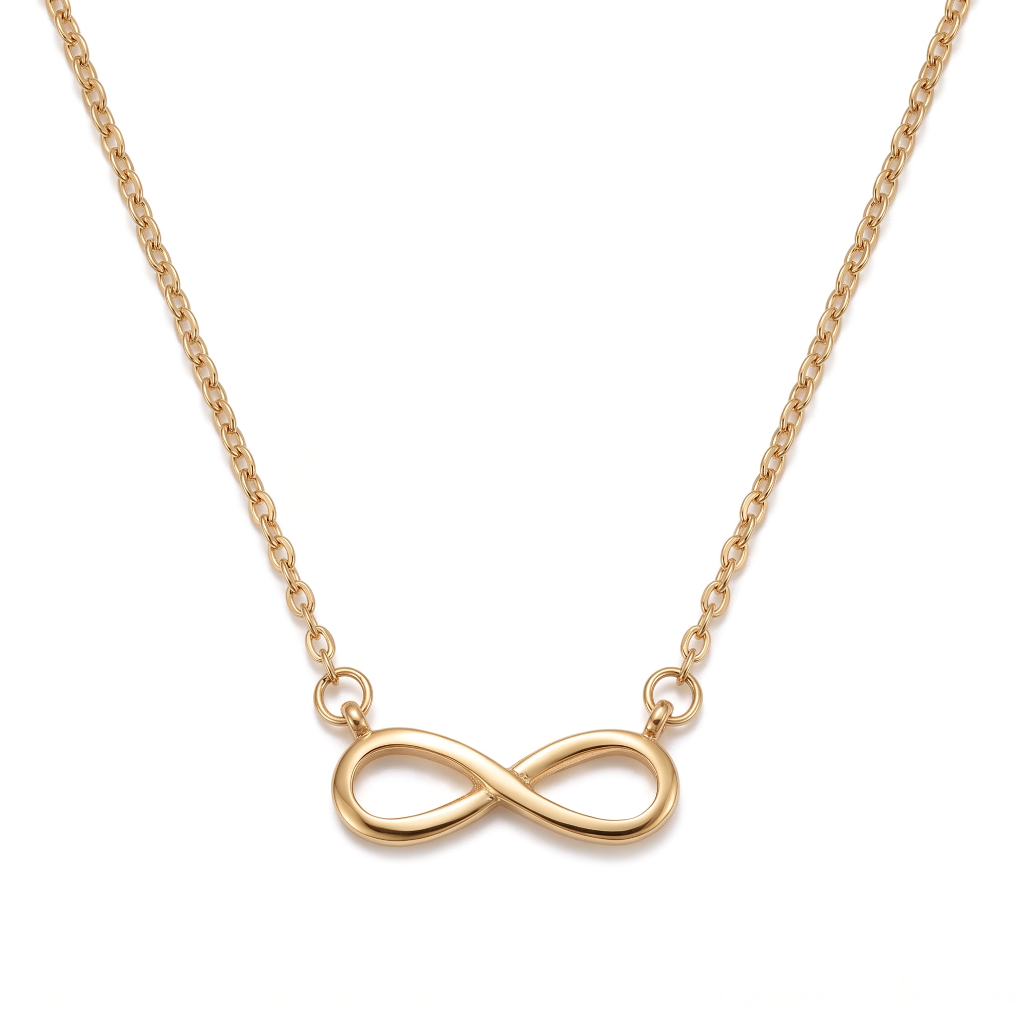 Gold infinity necklace laid out on a white background