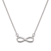 Silver infinity necklace laid out on a white background