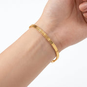 Gold fish scale chain bracelet worn on the wrist