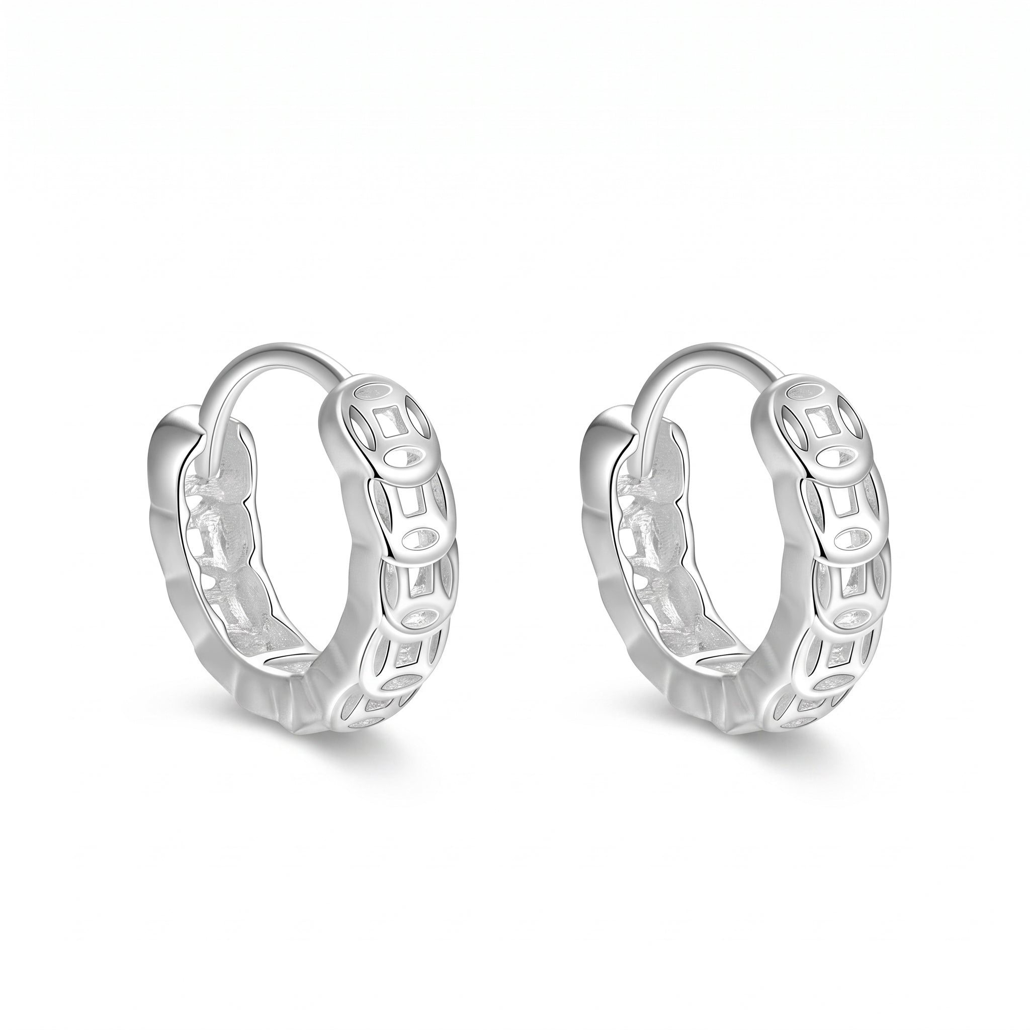 Silver coin huggie earrings side by side on white