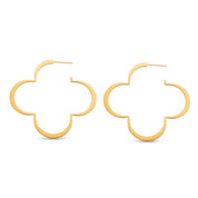 Pair of gold four leaf clover hoop earrings on white