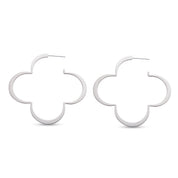 Pair of silver four leaf clover hoop earrings on white