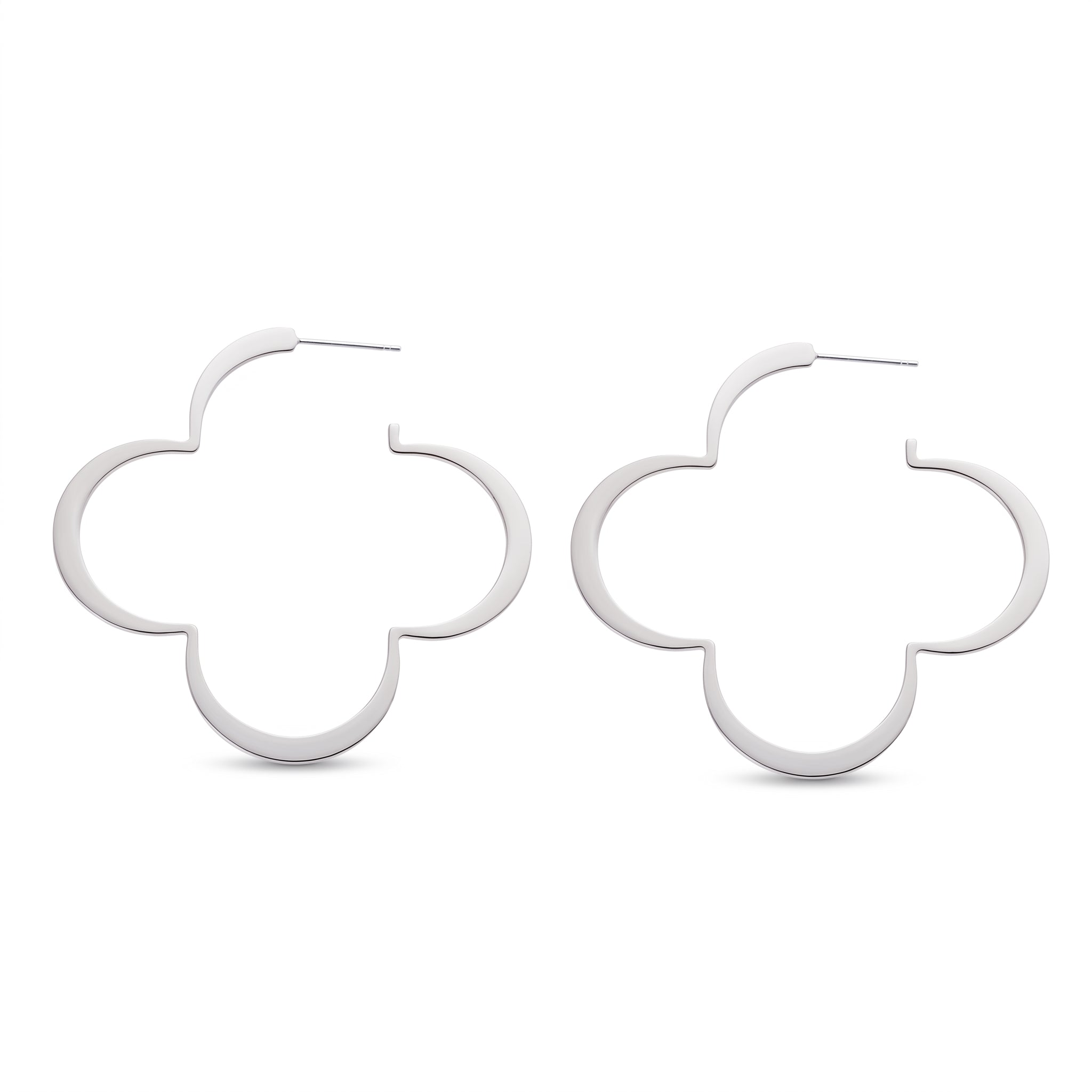 Pair of silver four leaf clover hoop earrings on white
