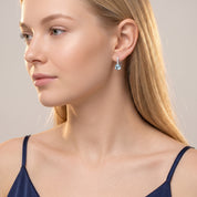 Silver blue crystal drop earrings worn with a navy camisole