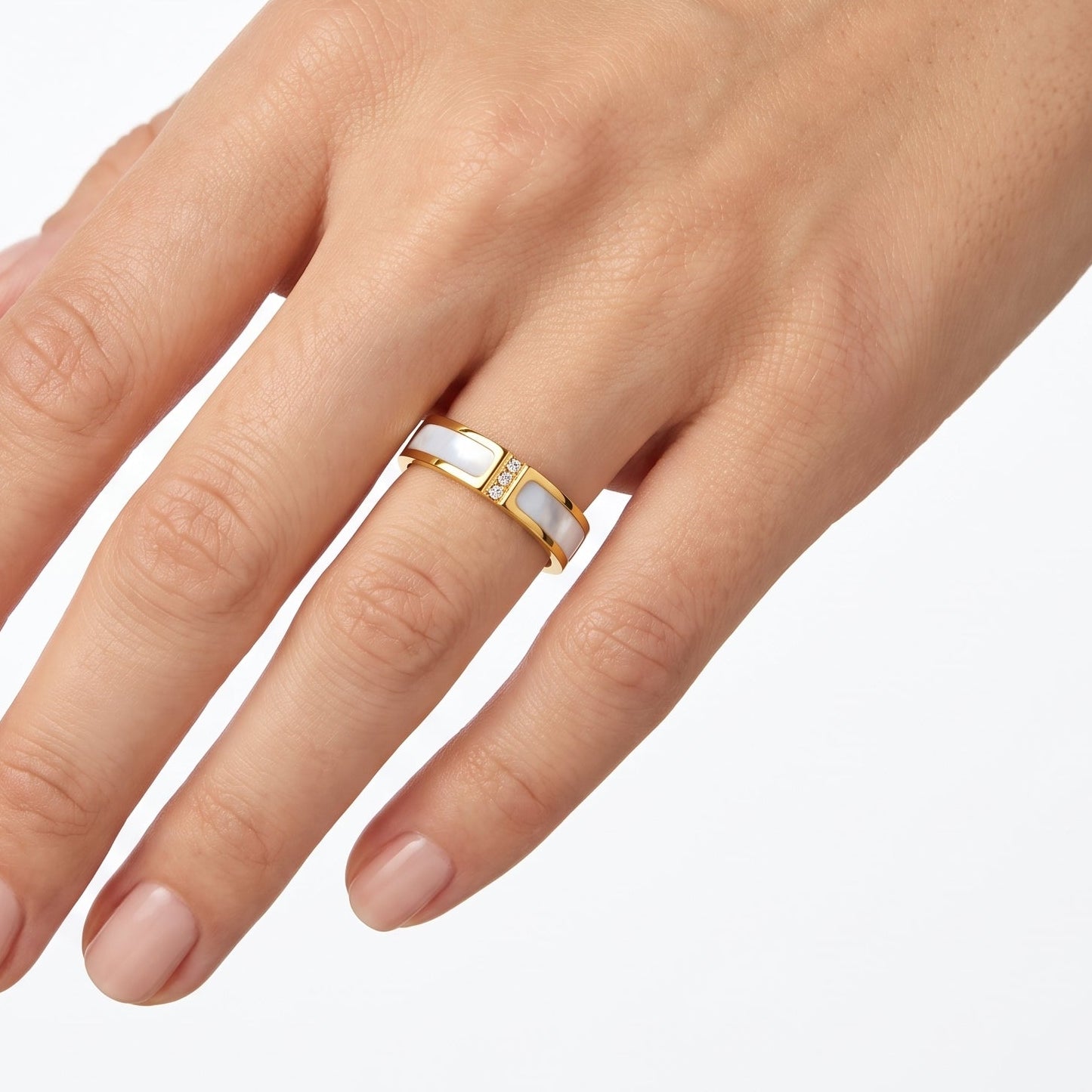 Gold mother of pearl band ring with crystals worn on the hand