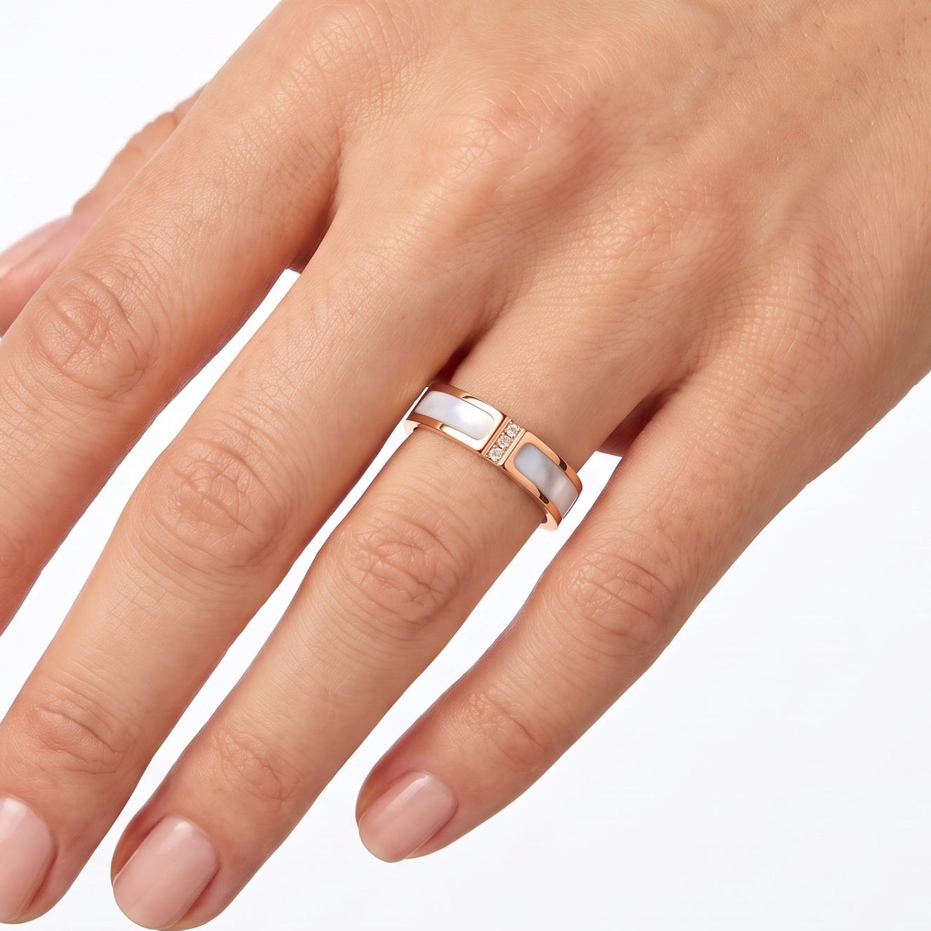 Rose gold mother of pearl band ring with crystals worn on the hand