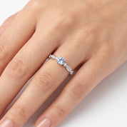 Fine silver ring with a light blue crystal on a hand