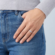 Hand at a jeans pocket wearing a dainty blue crystal ring