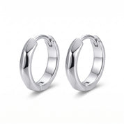 Silver faceted huggie hoops side by side on white