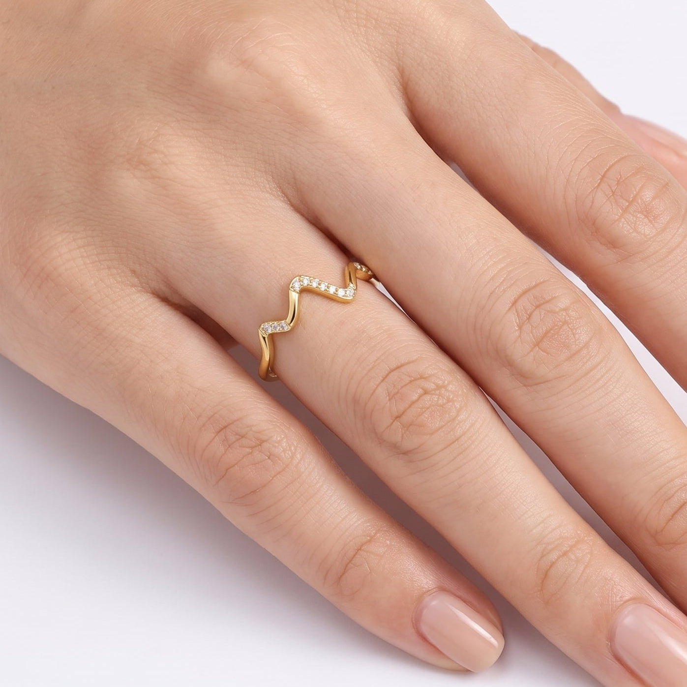 Gold zigzag wave ring with crystals worn on the hand
