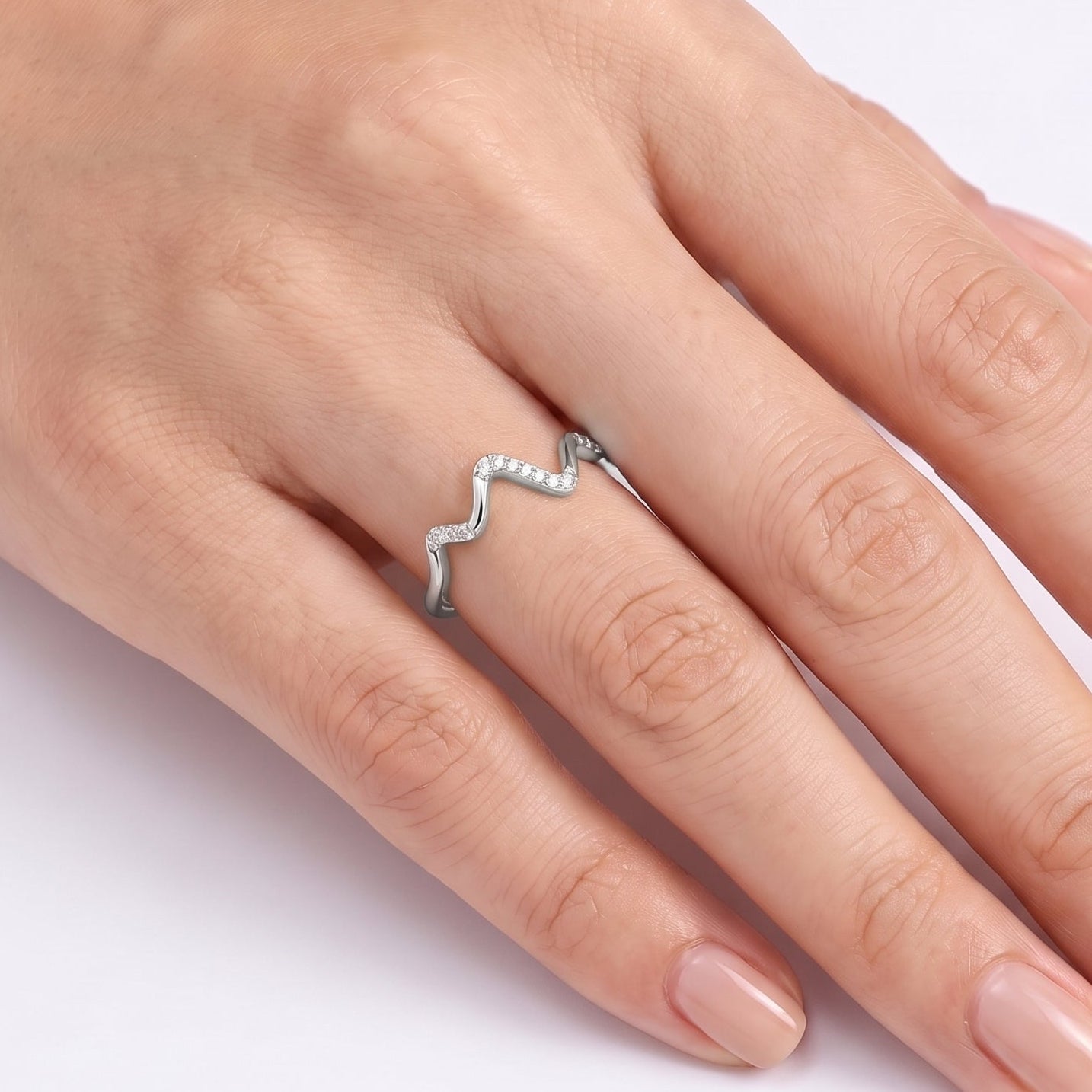 Silver zigzag wave ring with crystals worn on the hand