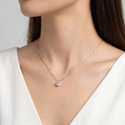 Silver solitaire crystal necklace on a sparkle chain, worn at the neck