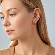 Gold double hoop earring in a soft side portrait