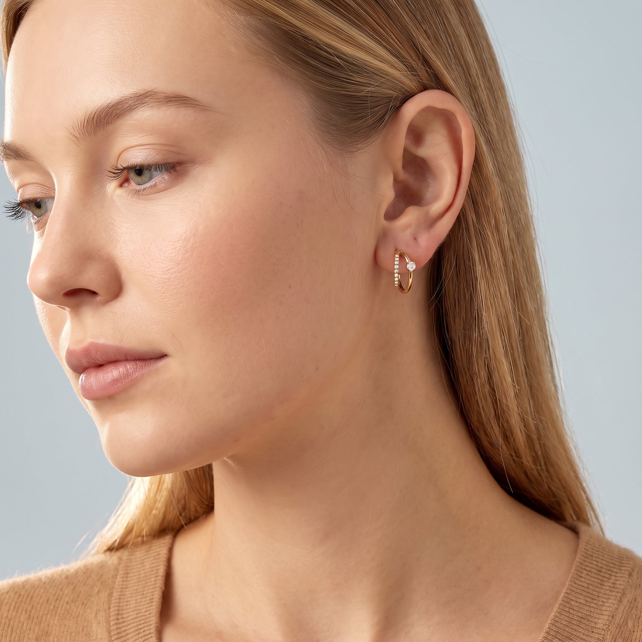 Gold double hoop earring in a soft side portrait