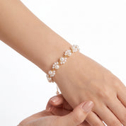 Gold pearl cluster bracelet worn on the wrist