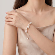 Gold pearl bracelet with the wrist across the body
