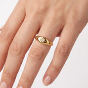 Gold star signet ring with crystal worn on the hand