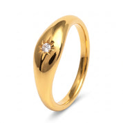 Gold star signet ring on white showing the domed top
