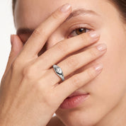 Silver star signet ring worn with the hand across the face