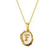 Maelle gold initial necklace, letter F on mother of pearl