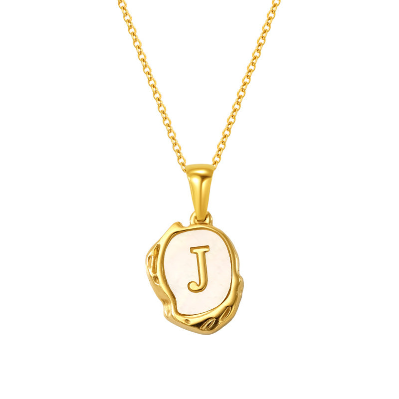 Maelle gold initial necklace, letter J on mother of pearl