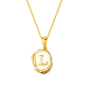 Maelle gold initial necklace, letter L on mother of pearl