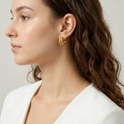 Gold textured triple hoop earring in side profile