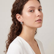 Silver textured triple hoop worn with a white V-neck top