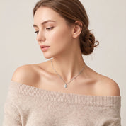 Silver bar necklace worn with hair up, side profile