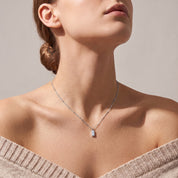 Silver bar necklace seen from below at the collarbone
