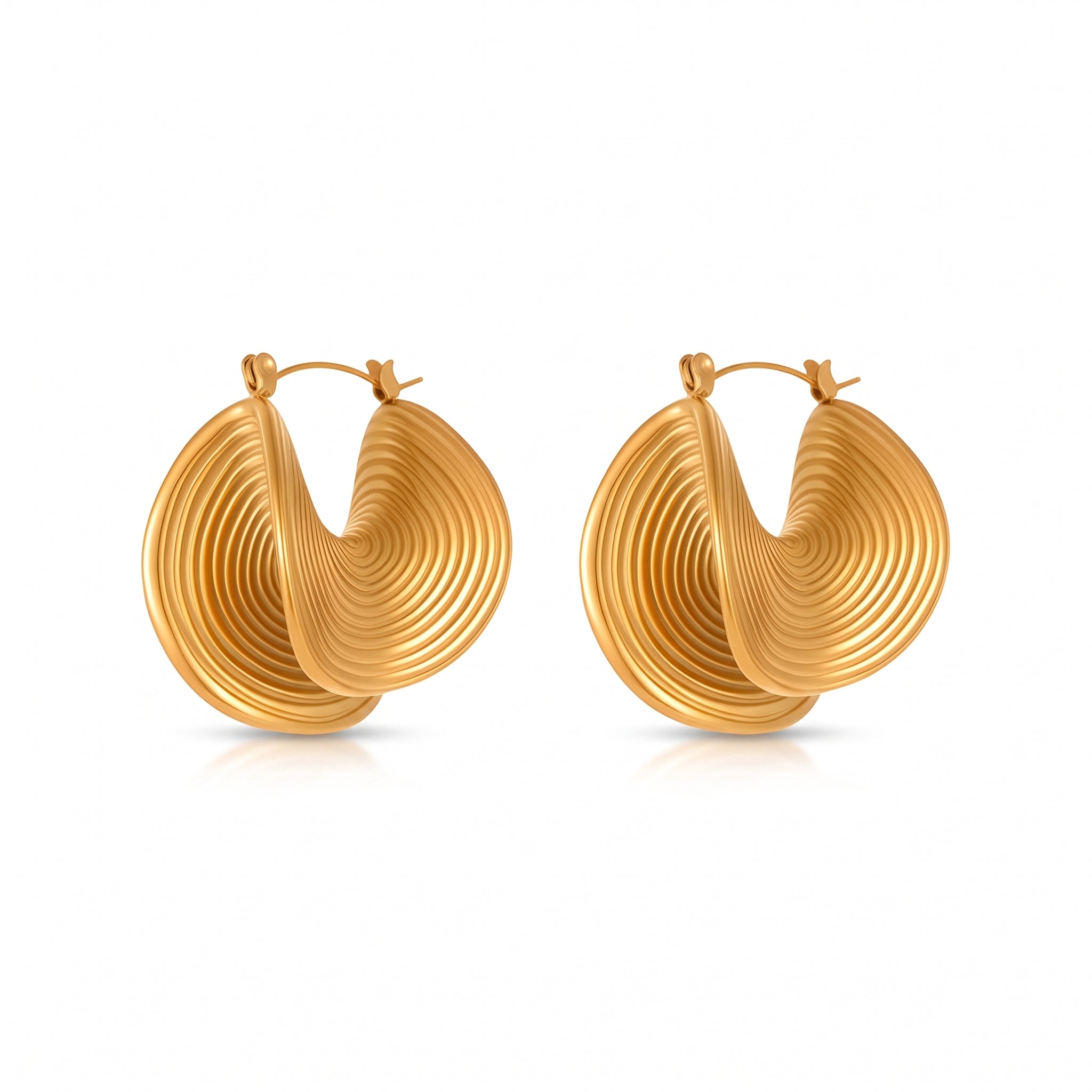Pair of gold spiral statement hoop earrings on white