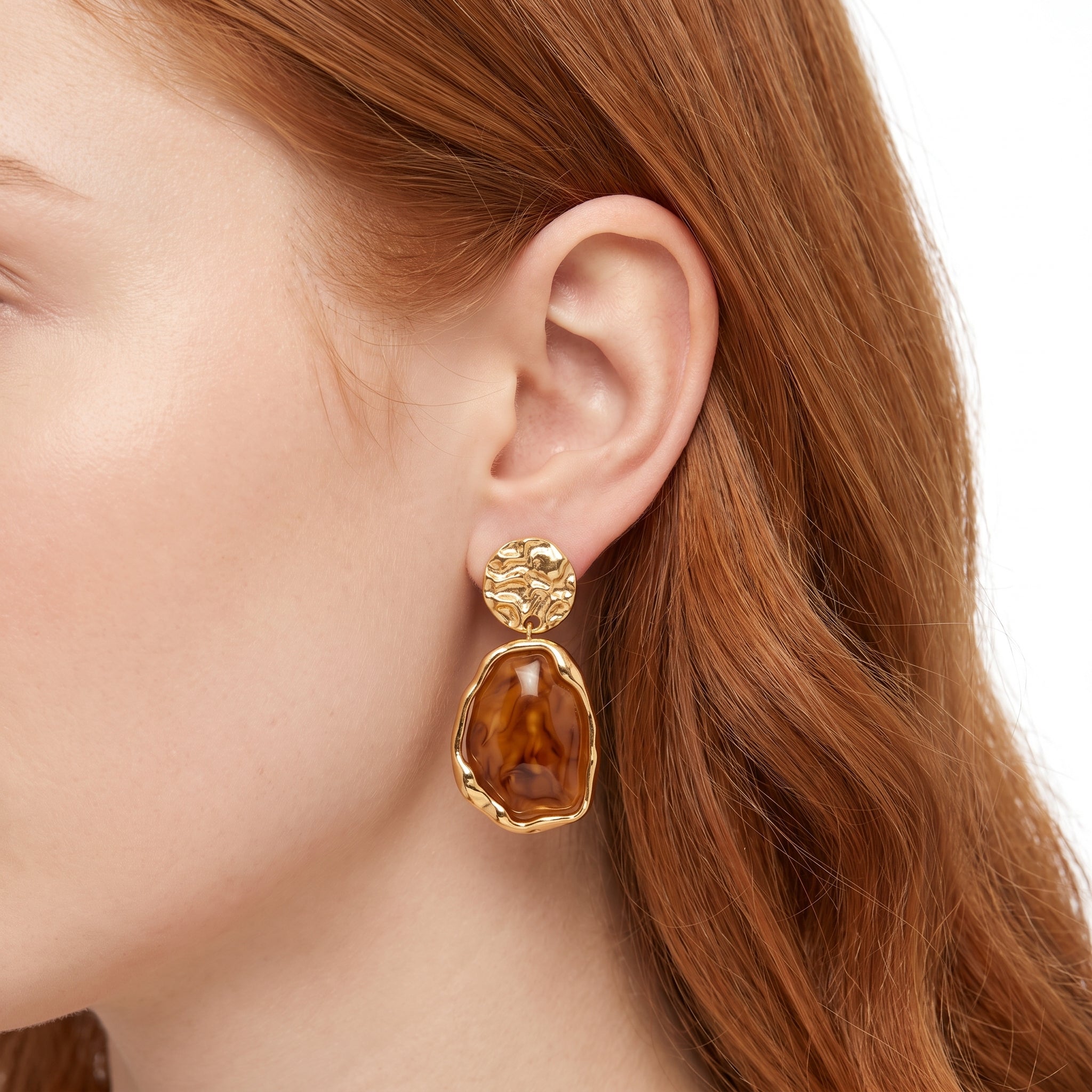Gold and amber resin drop earring with hammered disc stud, worn