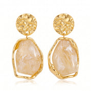 Gold cream resin drop earrings, pair side by side on white