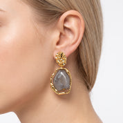 Gold and grey resin drop earring with hammered disc stud, worn