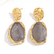 Gold grey resin drop earrings, pair side by side on white